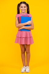 Wall Mural - School child with book. Learning and education. Happy teenager, positive and smiling emotions of teen schoolgirl.