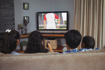 Canvas Print - Diverse children watching tv with football match on screen