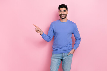 Wall Mural - Photo of positive cheerful man direct finger empty space blank proposition isolated on pink color background