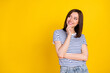 Photo of pretty cunning girl wear striped outfit arm touch face interested look empty space good idea isolated on yellow color background