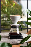 Fototapeta Sport - brewing coffee alternative method, coffee funnel stand on scales and brew hot drinks, coffee filter