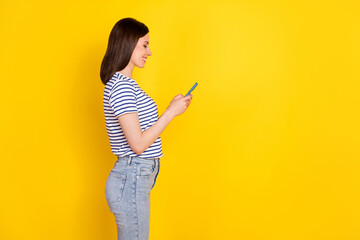 Sticker - Profile side photo of pretty funny lady arm hold use modern telephone device gadget stand empty space isolated on yellow color background