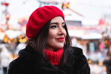 Beautiful Girl In A Red Beret And Mittens In Winter On New Year's Street