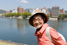 Japanese Senior Citizen Standing Against River.
