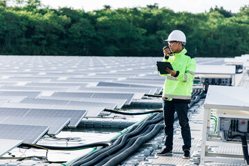 The portrait of a asian young engineer checks photovoltaic solar panels. Concept. renewable energy technology electricity service, green power.