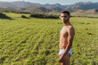 © ADDICTIVE STOCK - Man in underwear enjoying sunny day in mountains