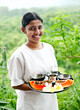 © Matthew Wakem - Woman Holding Papaya at Spa, , Dambulla, Sri Lanka. A spa therapist shows the raw ingredients for a Fruit Body scrub.