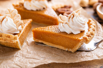 Wall Mural - Festive pumpkin pie slices decorated with whipped cream
