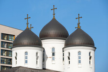 Black Domes Of The White Church With Crosses On The Blue Sky