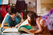 © Cavan Images - little girl in costume bugs brother while he reads a book