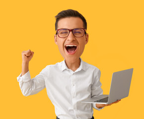 Wall Mural - Happy businessman with big head and laptop on yellow background