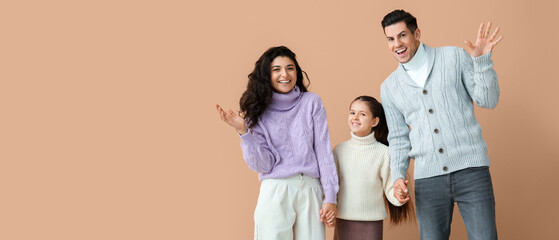 Sticker - Happy family in warm sweaters on beige background with space for text