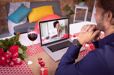 Sticker - Diverse couple making valentines date video call the woman on laptop screen holding i do sign