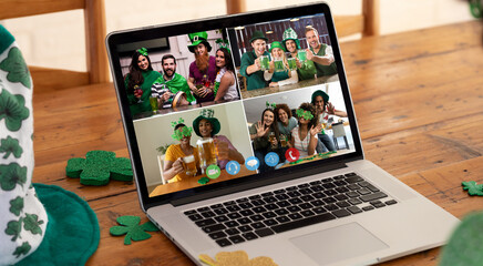 Poster - Diverse friends in costumes making st patrick's day video call displayed on laptop screen at home