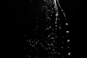  water splashes isolated on black background. white jets with drops