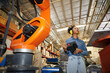 © offsuperphoto - factory worker or engineer operating remote switch controller to control robot machine in the factory