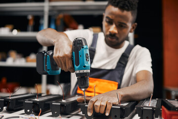 Wall Mural - male factory worker using electric screwdriver