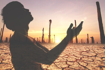 Wall Mural - Praying for rain, asking for water to survive the water shortage crisis. Concept of praying to God. Silhouette of a man praying.