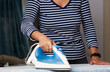 © Gecko Studio - Woman hand ironing clothes on ironing board