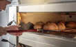 © Artem - The baker is a man in the process of baking bread. Production of bakery products as a small business