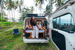 © Alexander White - young asian girl in camper van parked in a tropical coconut tree field in Bali Indonesia at sunset