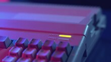 Closeup Of A Hand Inserting A Floppy Into A Microcomputer And Loading The Disk In A Dark Atmosphere