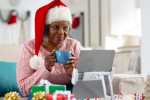 Thoughtful Senior African American Women Wearing Santa Claus Hat And Have Face Time