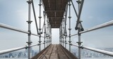 Fototapeta  - Construction scaffolding over a cityscape against clouds in the blue sky with copy space