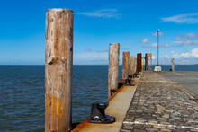Wooden Pillar Or Mooring Post Along A Quay In A Harbor