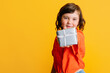 © ADDICTIVE STOCK - Girl showing present to camera