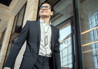 Wall Mural - Confident businessman man with glasses in a business suit