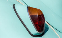 The Tail Light Of A Vintage Retro Car. Retro Car Brake Light. The Rear Fender Of A Vintage Car Is Pistachio-colored.