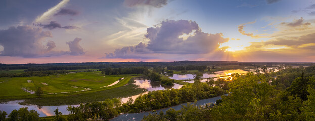 beautiful panorama of missouri river floodplain converted to wildlife conservation area at sunset; m