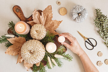 Diy rustic autumn table decoration. Floral interior decor for fall holidays with handmade pumpkins. Flatlay, top view