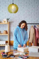 Wall Mural - Young woman packing boxes to be shipped.  Оnline store, small business owner, seller, entrepreneur, packing bag, mailbox.