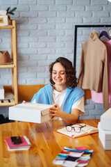 Wall Mural - Young woman packing boxes to be shipped.  Оnline store, small business owner, seller, entrepreneur, packing bag, mailbox.