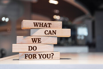 Wall Mural - Wooden blocks with words 'What Can We Do For You?'.