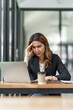 © Phushutter - Stress asian business woman after working hard at office workplace.