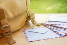 Mail Envelopes And Canvas Shoulder Bag On Wooden Table