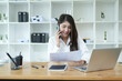 © maeching - Asian business woman Use a laptop computer and work at the office ready. plan to analyze financial reports