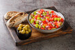 Trampo is a typical peppers tomatoes salad in Majorca Spain closeup on the wooden board on the table. Horizontal