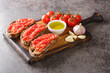 © FomaA - Spanish tomato toast pan tomaca or tostadas con tomate closeup on the wooden board on the table. Horizontal
