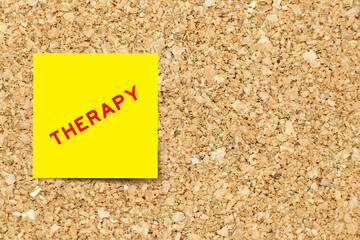 Sticker - Yellow note paper with word therapy on cork board background with copy space