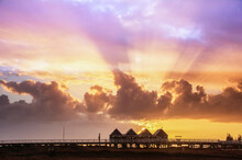 View Of Busselton Jetty Silhouette With Sun Rays Shining Through Clouds