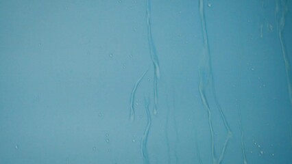 Wall Mural - slow motion water rain drop falling on shiny luxury blue background