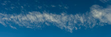 Stripe Of Cirrus Clouds Against The Blue Sky.