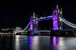 Tower Bridge at night lit in purple honouring the Queen