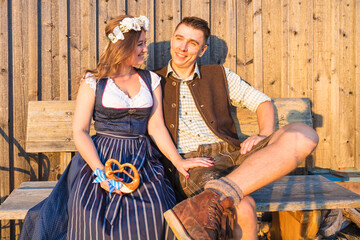 Wall Mural - Oktoberfest, woman and man in Bavarian costume with beer mugs