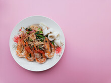Rice Vermicelli Noodles Seafood Spicy Salad On Pink Background With Copy Space