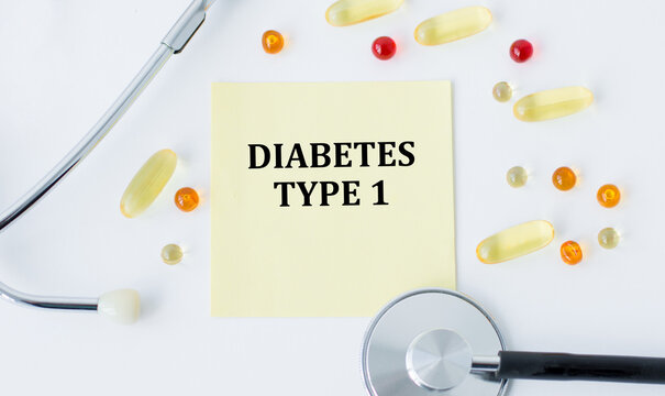 Diabetes type 1 text on a card on a white background next to it lies a stethoscope and scattered tablets